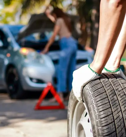 Mecánico reparando las llantas de un vehículo particular en referencia a la cobertura del seguro de responsabilidad civil vehicular de Seguros Caracas