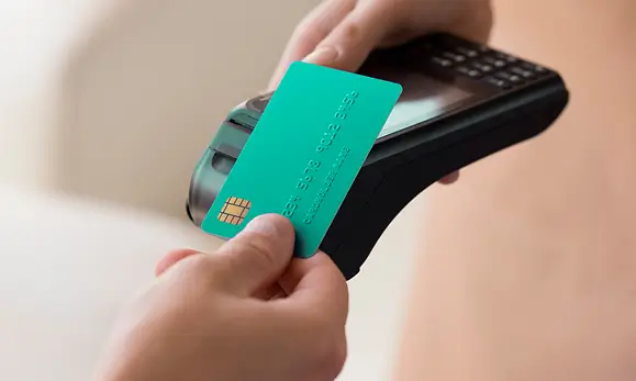 Paciente haciendo un pago con su tarjeta de crédito en referencia a los Métodos de pago de Seguros Caracas